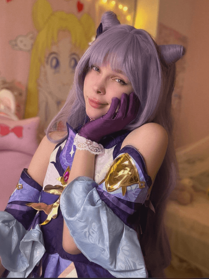 Person in anime cosplay with lavender wig and cat ears, purple-blue armor, resting chin on gloved hand.
